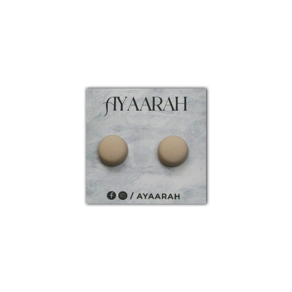 Pair of beige earrings on a gray card with 'AYAARAH' branding.